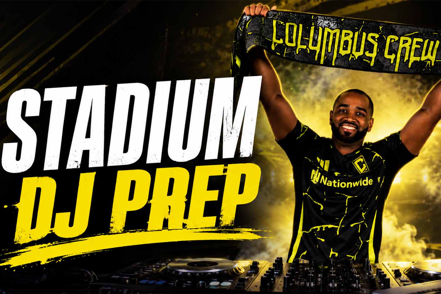 DJ AXCESS holding a Columbus Crew scarf while preparing music for a pro sports event.